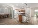 An open layout kitchen with bar stool seating, stainless steel appliances, and pendant lights at 20025 W Madison St, Buckeye, AZ 85326