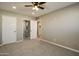 Bright bedroom with ceiling fan and access to bathroom at 9622 W Cinnabar Ave # B, Peoria, AZ 85345