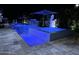 Night view of resort-style pool with water features and spa at 2652 E Pelican Ct, Gilbert, AZ 85297