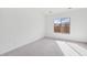 Well-lit bedroom featuring grey carpet and large window at 22837 E Alyssa Rd, Queen Creek, AZ 85142