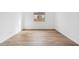 Spacious bedroom with wood-look tile flooring and large window at 22837 E Alyssa Rd, Queen Creek, AZ 85142