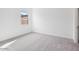 Bright bedroom with grey carpet and large window at 22837 E Alyssa Rd, Queen Creek, AZ 85142
