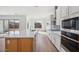 Modern kitchen with island, white cabinets, and stainless steel appliances at 22837 E Alyssa Rd, Queen Creek, AZ 85142