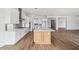 Open kitchen features a large island and wood flooring at 22837 E Alyssa Rd, Queen Creek, AZ 85142
