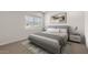 This is a contemporary bedroom with gray furniture, white walls, neutral carpet and a serene aesthetic at 7453 S 75Th Dr, Laveen, AZ 85339