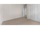 Empty bedroom featuring neutral carpet, white trim and two doors at 7453 S 75Th Dr, Laveen, AZ 85339