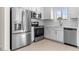 Modern kitchen with stainless steel appliances and white cabinetry at 7453 S 75Th Dr, Laveen, AZ 85339