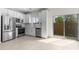 Bright, modern kitchen with stainless steel appliances and a sliding glass door at 7453 S 75Th Dr, Laveen, AZ 85339