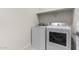 A laundry area is shown with a shelf and two white appliances at 7453 S 75Th Dr, Laveen, AZ 85339