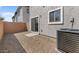Here's a small, gravel-filled patio with an air conditioning unit, exterior walls, and sliding door at 7453 S 75Th Dr, Laveen, AZ 85339