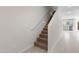 Bright staircase featuring carpeted steps and modern lighting, connecting to the kitchen area at 7453 S 75Th Dr, Laveen, AZ 85339