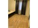 Simple bedroom layout featuring neutral walls, wood floors and decorative black out curtains at 12009 W Aster Dr, El Mirage, AZ 85335