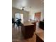 Spacious kitchen with island, dining area, and tile flooring, creating a warm and inviting atmosphere at 12009 W Aster Dr, El Mirage, AZ 85335