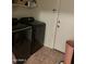 Modern laundry room equipped with sleek appliances and tiled floor for convenient chores at 12009 W Aster Dr, El Mirage, AZ 85335