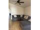 Inviting living room with a large sectional sofa and ceiling fan, perfect for relaxation at 12009 W Aster Dr, El Mirage, AZ 85335