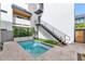 Backyard pool featuring clean and modern design, steps to balcony, neutral paving, and verdant garden at 6914 E 2Nd St, Scottsdale, AZ 85251