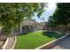 Spacious backyard with covered patio, lush grass, and raised garden beds at 1538 E Windsong Dr, Phoenix, AZ 85048