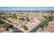 Expansive aerial view of a neighborhood showcasing numerous homes, manicured landscaping and community features at 17552 W Young St, Surprise, AZ 85388