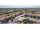 Wide aerial of a community with lush landscaping, single-Gathering homes and neighborhood streets in a vibrant area at 17552 W Young St, Surprise, AZ 85388