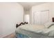 Simple bedroom with a wood bed frame, carpet flooring, and white walls, offering a clean, minimalist space at 17552 W Young St, Surprise, AZ 85388
