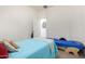 Cozy bedroom featuring twin beds, neutral walls, and open doorway at 17552 W Young St, Surprise, AZ 85388