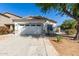 Charming single-story home featuring a well-maintained front yard and a two-car garage at 17552 W Young St, Surprise, AZ 85388