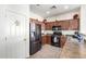 Efficient kitchen with dark wood cabinets, stainless steel refrigerator, and modern appliances at 17552 W Young St, Surprise, AZ 85388