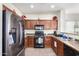 Functional kitchen with dark wood cabinets and stainless-steel appliances at 17552 W Young St, Surprise, AZ 85388