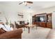 Comfortable living room showcasing plush carpets, inviting brown sofas, and stylish wall decor at 17552 W Young St, Surprise, AZ 85388