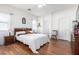 Bright main bedroom with wood floors, a king bed, and white walls, creating a serene atmosphere at 17552 W Young St, Surprise, AZ 85388