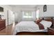 Sunlit main bedroom with wood floors, a king bed, and neutral decor, offering a relaxing space at 17552 W Young St, Surprise, AZ 85388