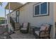 Relaxing back porch seating area with patio chairs and side table at 2233 E Behrend Dr # 210, Phoenix, AZ 85024