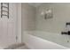 Clean and modern bathroom with a tub and tiled shower, accented with a minimalist design at 2233 E Behrend Dr # 210, Phoenix, AZ 85024