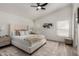 Bright bedroom featuring a comfortable upholstered bed, ceiling fan, and neutral decor at 2233 E Behrend Dr # 210, Phoenix, AZ 85024