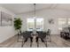 Elegant dining area with a glass-top table set, ample seating, and bright natural light at 2233 E Behrend Dr # 210, Phoenix, AZ 85024