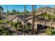 An angled view shows this complex property with a bridge feature and mature landscaping on a sunny day at 2233 E Behrend Dr # 210, Phoenix, AZ 85024