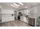 Modern kitchen featuring white cabinets, sleek countertops, stainless steel appliances, and ample natural light at 2233 E Behrend Dr # 210, Phoenix, AZ 85024