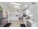 Bright kitchen featuring updated stainless steel appliances, ample storage, and laundry in the background at 2233 E Behrend Dr # 210, Phoenix, AZ 85024
