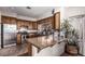 Well-appointed kitchen with wood cabinets, stainless steel appliances, and granite countertops provides functionality and style at 2233 E Behrend Dr # 210, Phoenix, AZ 85024