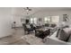 Bright and airy living space with modern decor, ceiling fan, and seamless flow to the dining area at 2233 E Behrend Dr # 210, Phoenix, AZ 85024