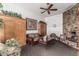 Cozy living room with a stone fireplace, wood cabinets, and comfortable seating offers a warm, inviting space at 2233 E Behrend Dr # 210, Phoenix, AZ 85024