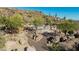 An elevated pool area is nestled among boulders and desert vegetation, offering privacy and scenic views at 2233 E Behrend Dr # 210, Phoenix, AZ 85024
