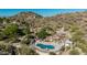 Unique kidney-shaped pool with a stone waterfall feature in a desert landscape, perfect for relaxation at 2233 E Behrend Dr # 210, Phoenix, AZ 85024