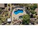 An aerial view shows a uniquely shaped pool with a waterfall and ample seating at 2233 E Behrend Dr # 210, Phoenix, AZ 85024