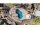 Overhead view of a uniquely shaped pool with an umbrella table and desert landscaping at 2233 E Behrend Dr # 210, Phoenix, AZ 85024