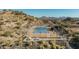 Aerial view of a tennis court surrounded by desert mountain views at 2233 E Behrend Dr # 210, Phoenix, AZ 85024