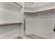 Spacious walk-in closet with wood closet rods and shelving at 2233 E Behrend Dr # 210, Phoenix, AZ 85024