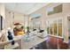 Bright living room with hardwood floors, high ceilings, plantation shutters, and large windows showcasing the outdoor view at 6711 E Camelback Rd # 21, Scottsdale, AZ 85251