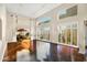 Bright living room with hardwood floors, high ceilings, plantation shutters, and large windows showcasing the outdoor view at 6711 E Camelback Rd # 21, Scottsdale, AZ 85251