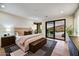 Bright bedroom with king-size bed and access to a private patio at 9930 E Miramonte Dr, Scottsdale, AZ 85262